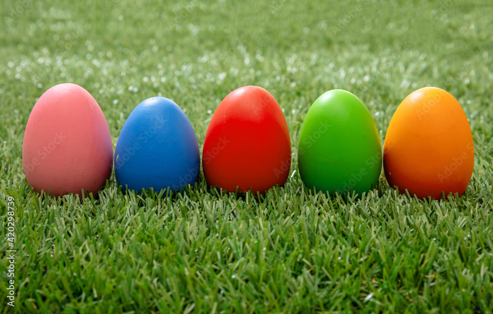 Happy Easter. Colorful eggs on green grass, close up view Happy Easter. Colorful eggs on green grass, close up view