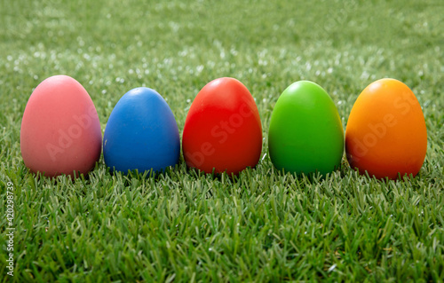 Happy Easter. Colorful eggs on green grass, close up view