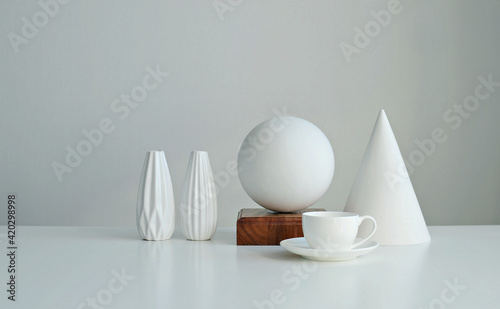 Stylish interior mockup with white geometric shapes of a ball and a cone