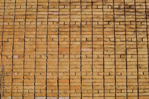 Old yellow brick wall background 