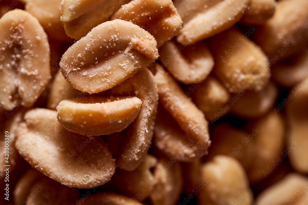 Salted peanuts on a wooden background. With copy space.Macro effect photo. Salted peanuts on a wooden background. With copy space.Macro effect photo.