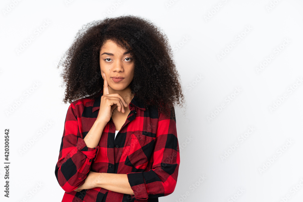 Young african american woman over isolated background and thinking Young african american woman over isolated background and thinking
