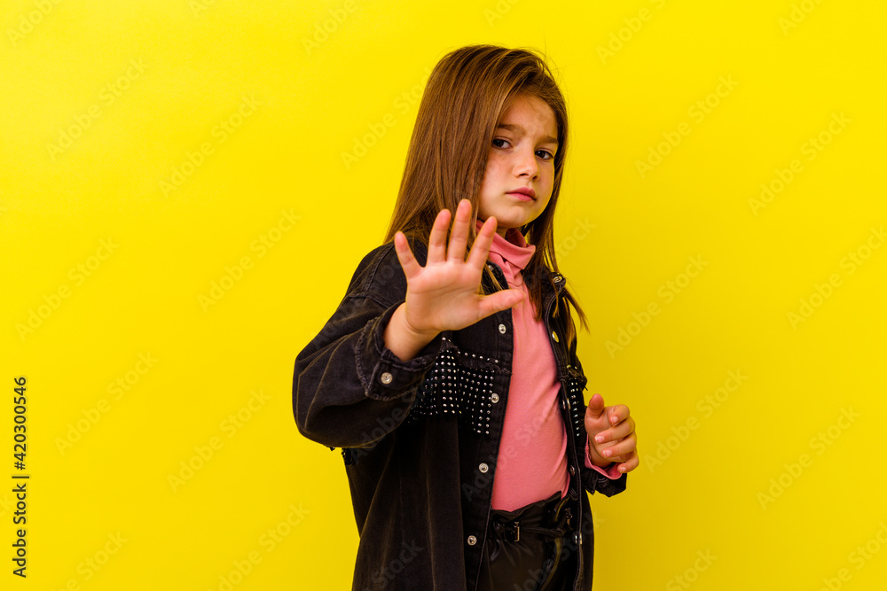 Little caucasian girl isolated on yellow background being shocked due to an imminent danger Little caucasian girl isolated on yellow background being shocked due to an imminent danger