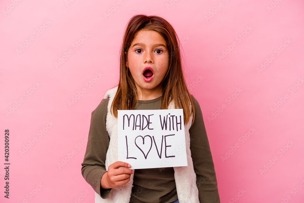 Little girl holding a made with love banner isolated Little girl holding a made with love banner isolated