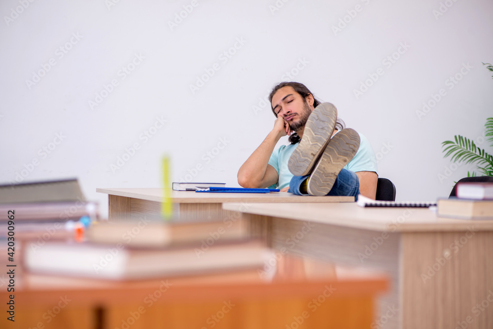 Young male student in the classroom during pandemic Young male student in the classroom during pandemic