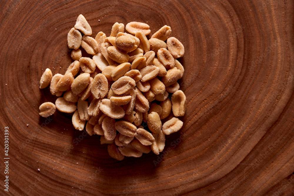 Salted peanuts on a wooden background. With copy space.Macro effect photo. Salted peanuts on a wooden background. With copy space.Macro effect photo.