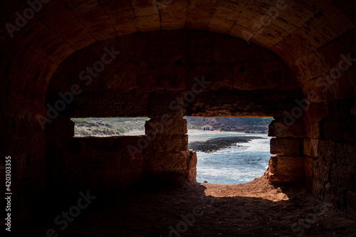 Interior of an abandoned bunkear near Algaiarens beach in a clear day with blue sky  located in the north of Minorca  in Balearic Islands  Spain.