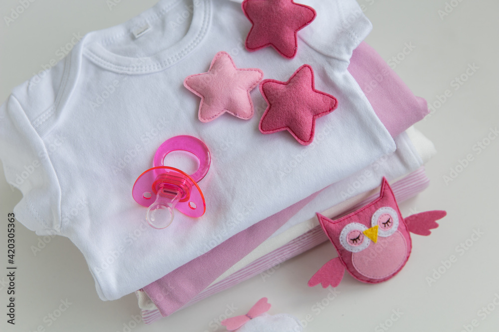 infant baby clothes baby girl pacifier cap on background infant baby clothes baby girl pacifier cap on background