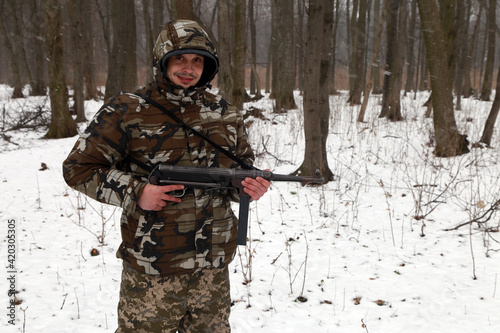 The man with submachine gun in the forest