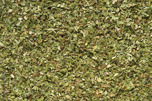 Pile of dried green oregano texture or background. photo