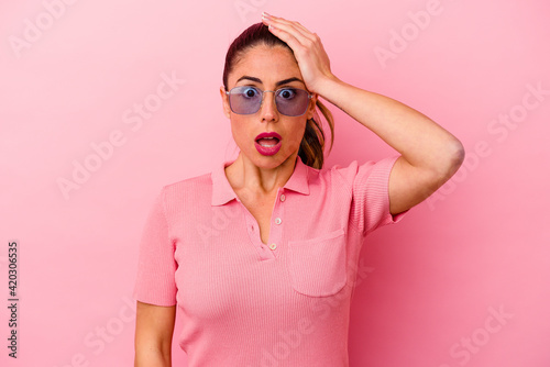 Young caucasian woman isolated on pink background © Asier