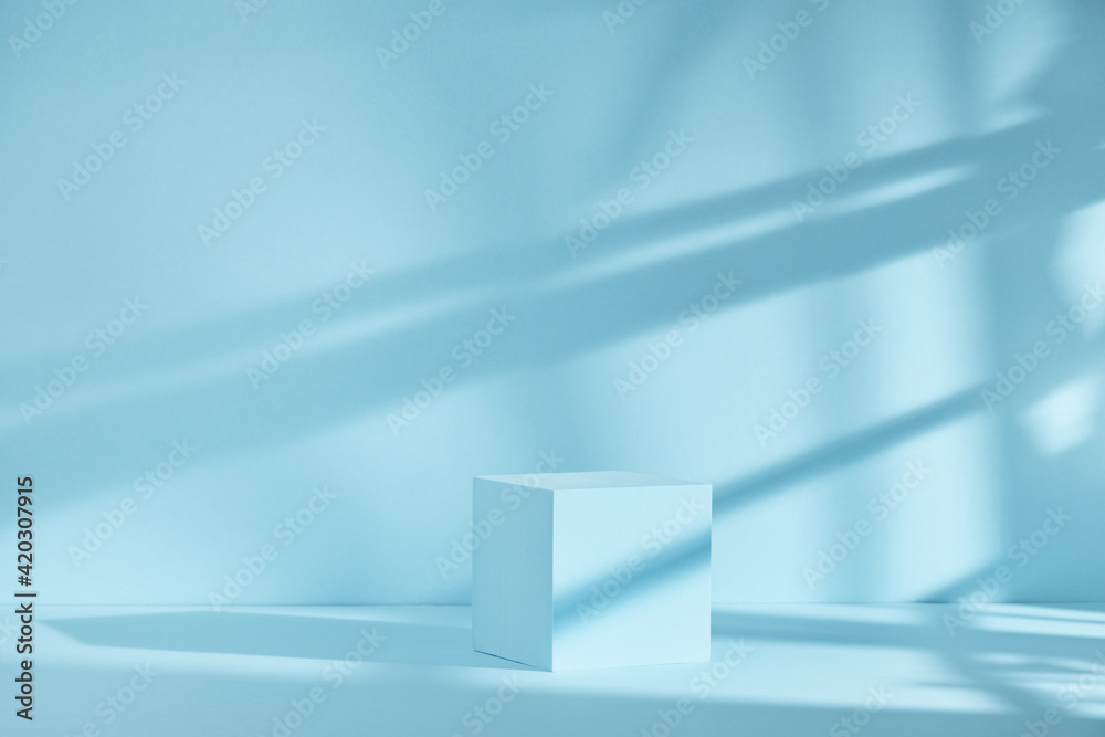 Fototapeta premium Blue background for product presentation with shadows and light. Empty cubic podium. Mockup.