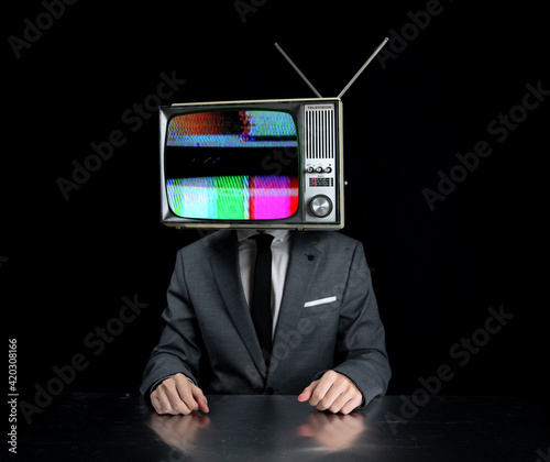 Man wearing suit with TV on head