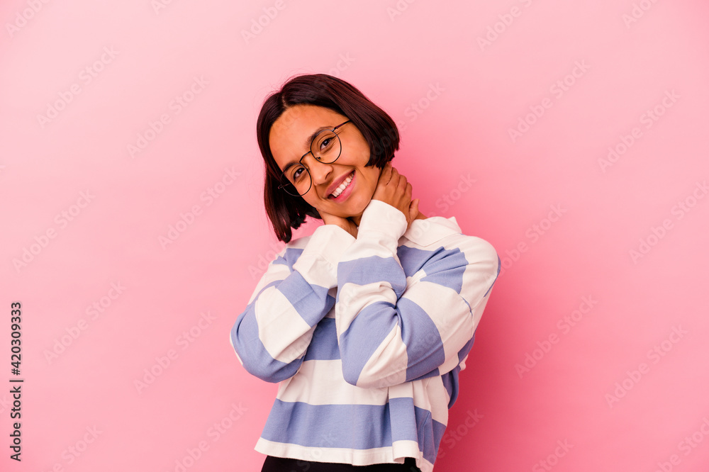 Young mixed race woman isolated on pink background feeling confident, with hands behind the head. Young mixed race woman isolated on pink background feeling confident, with hands behind the head.