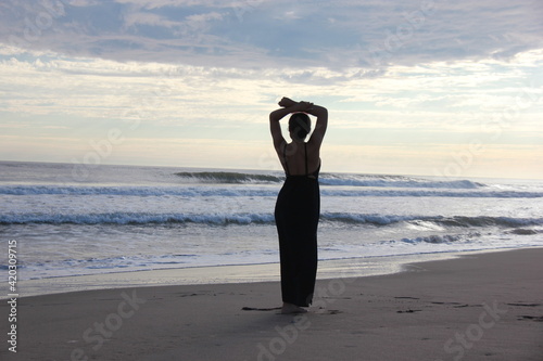 Silhouette of a woman by the beach.
