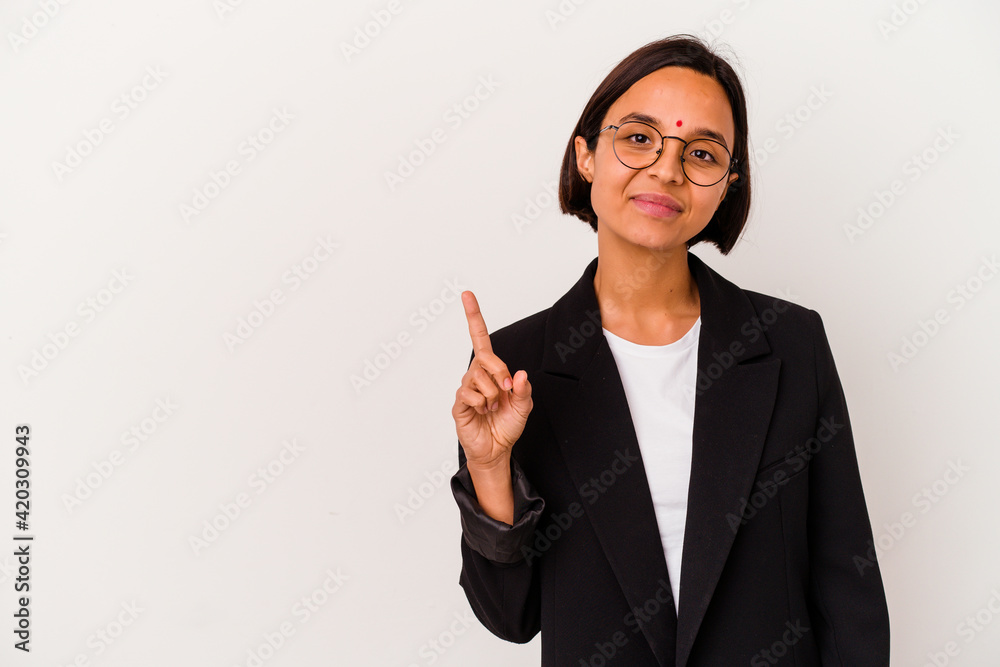 Young business Indian woman isolated on white background showing number one with finger. Young business Indian woman isolated on white background showing number one with finger.