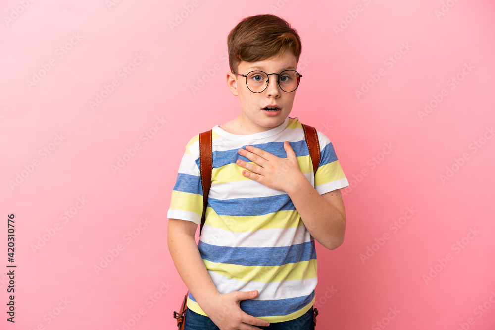 Little redhead caucasian boy isolated on pink background surprised and shocked while looking right Little redhead caucasian boy isolated on pink background surprised and shocked while looking right