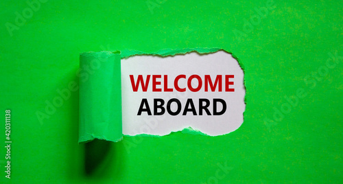 Welcome aboard symbol. Words 'Welcome aboard' appearing behind torn green paper. Beautiful green background. Business, welcome aboard concept, copy space.