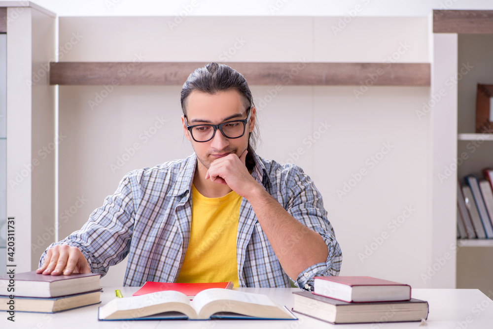 Young male student preparing for exam at home Young male student preparing for exam at home