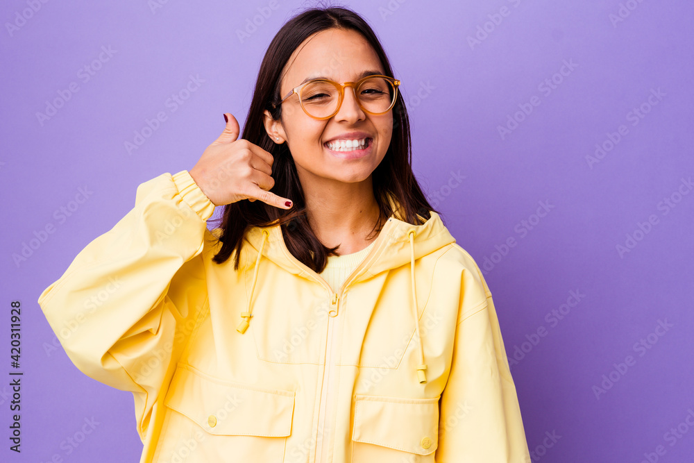 Young mixed race woman isolated showing a mobile phone call gesture with fingers. Young mixed race woman isolated showing a mobile phone call gesture with fingers.