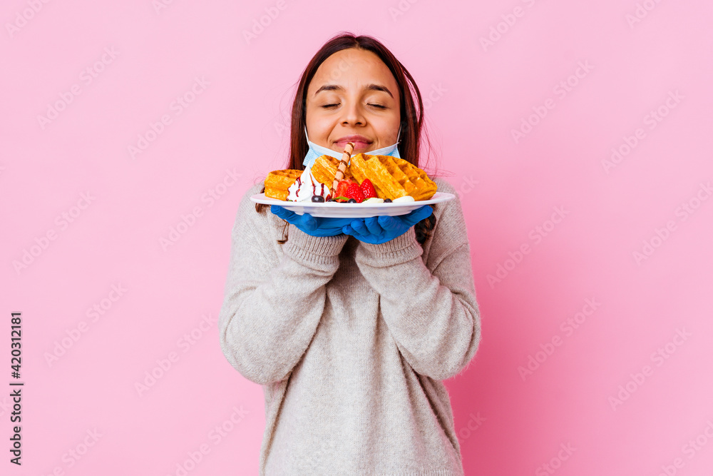 Young surgeon woman holding a waffle isolated