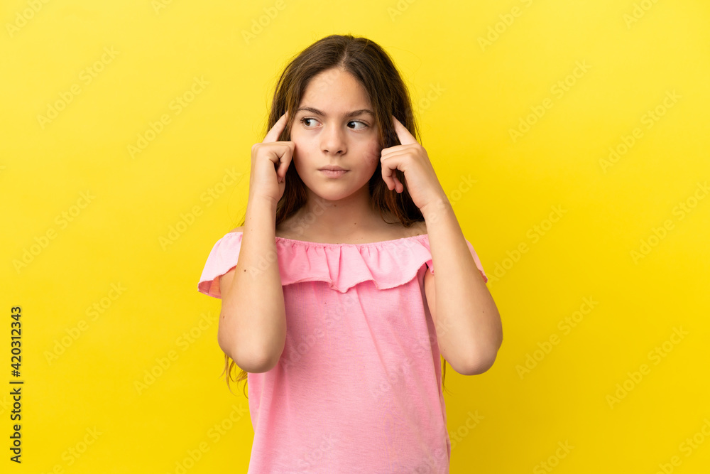 Little caucasian girl isolated on yellow background having doubts and thinking Little caucasian girl isolated on yellow background having doubts and thinking