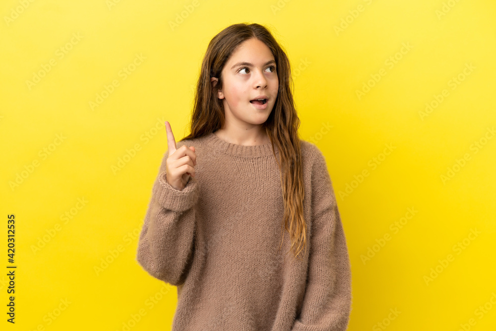 Little caucasian girl isolated on yellow background thinking an idea pointing the finger up Little caucasian girl isolated on yellow background thinking an idea pointing the finger up