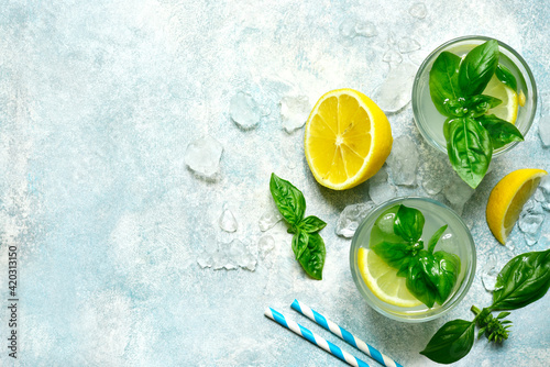 Cold summer lemonade with basil and lemon. Top view with copy space.
