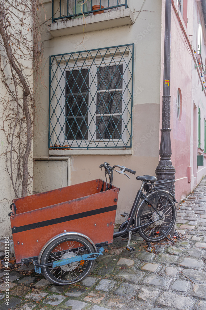 Paris, France - 02 26 2021: Montmartre district. A tricycle parked along a wall