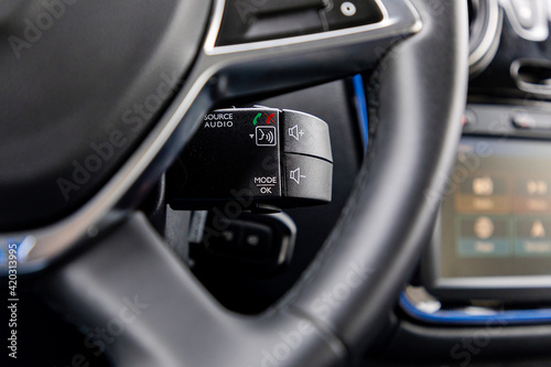 Audio controls below the steering wheel in a car