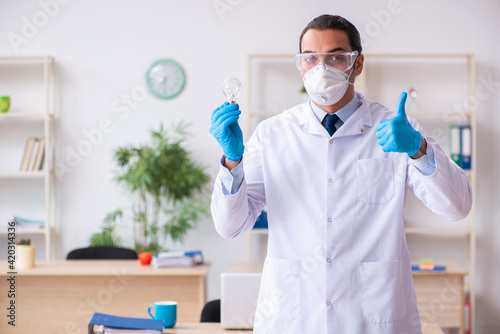 Young male doctor virologist in the office