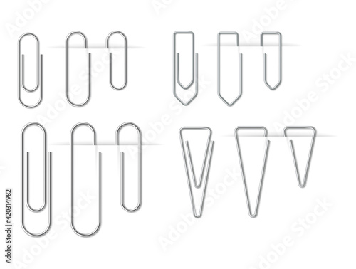 Realistic metal silver paper clips set isolated and attached on white background