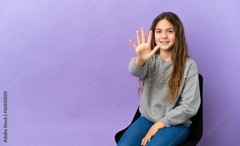 Little caucasian girl sitting on a chair isolated on purple background counting five with fingers Little caucasian girl sitting on a chair isolated on purple background counting five with fingers