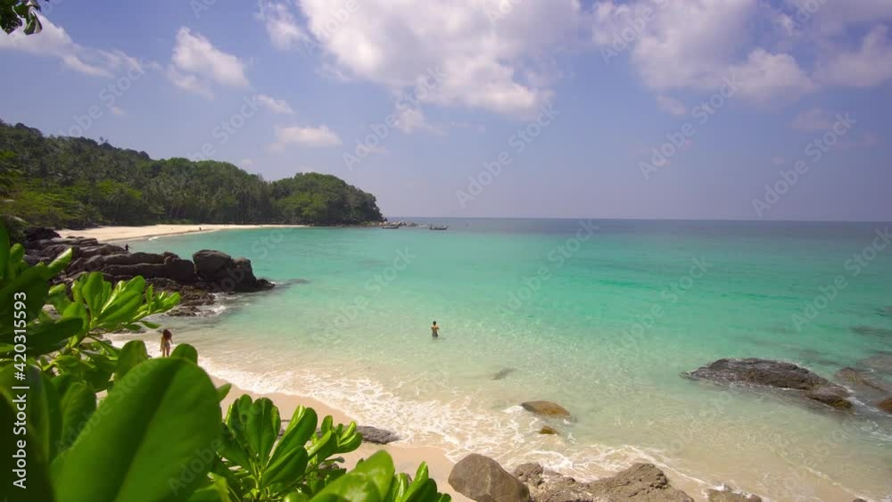 Aerial view shot. Drone camera over white beach sand and sew water clear. Nature video view of beautiful tropical beach and sea in sunny day. Palm tree at beach. At Phuket, Thailand. Aerial view shot. Drone camera over white beach sand and sew water clear. Nature video view of beautiful tropical beach and sea in sunny day. Palm tree at beach. At Phuket, Thailand.