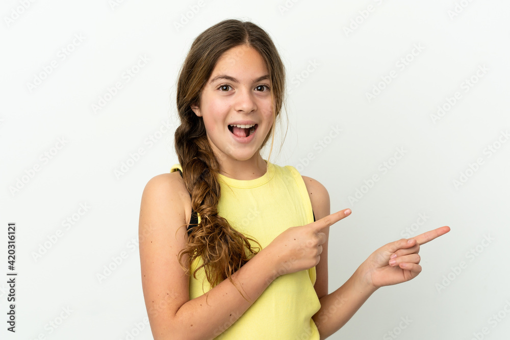 Little caucasian girl isolated on white background surprised and pointing side Little caucasian girl isolated on white background surprised and pointing side