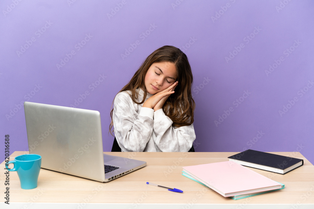 Little student girl in a workplace with a laptop isolated on purple background making sleep gesture in dorable expression Little student girl in a workplace with a laptop isolated on purple background making sleep gesture in dorable expression