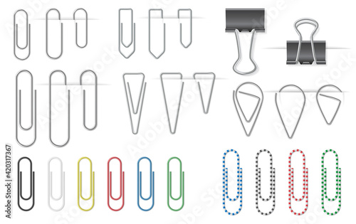 Set of metal paper clips isolated on white background attached to paper