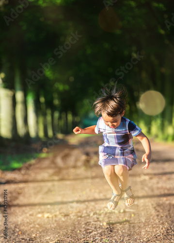 little girl jumping in the nature
