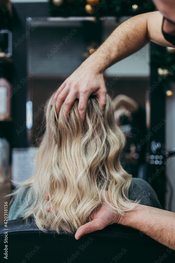 Naklejka premium Beautiful hairstyle of woman after dyeing hair and making highlights in hair salon.
