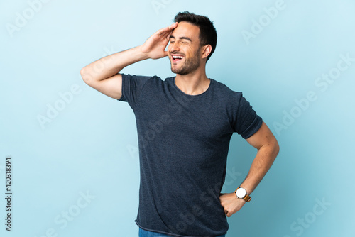 Young handsome man over isolated background smiling a lot © luismolinero