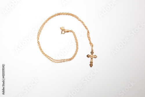 Gold cross with chain, cross for the baptism of a Christian baby.