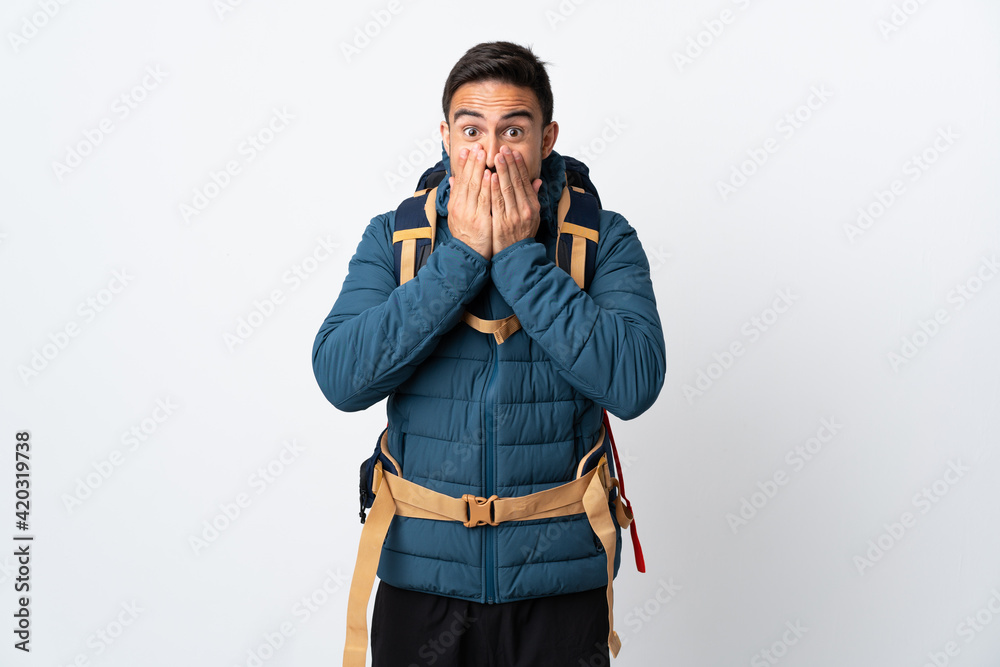Young mountaineer man with a big backpack isolated on white background with surprise facial expression Young mountaineer man with a big backpack isolated on white background with surprise facial expression