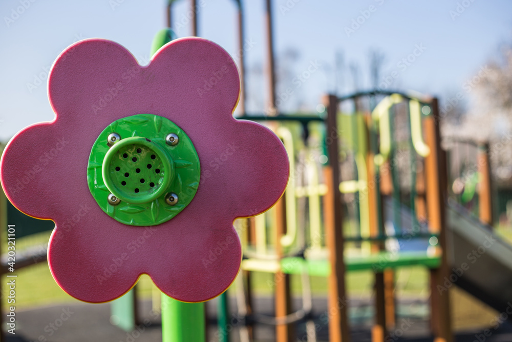 Pink man made flower close up in a kids playground