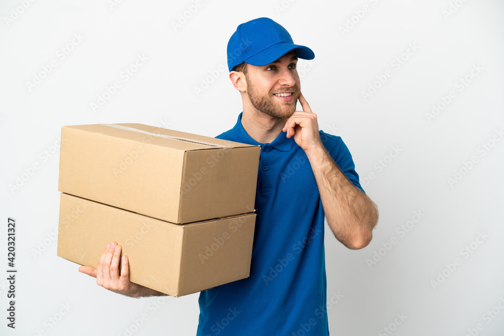 Delivery man over isolated white background thinking an idea while looking up Delivery man over isolated white background thinking an idea while looking up