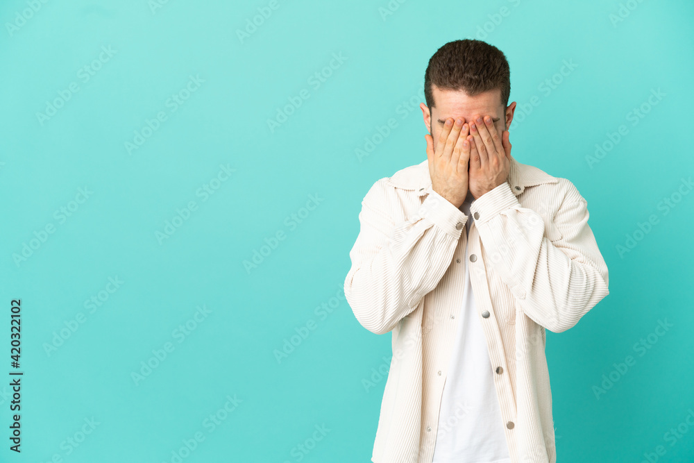 Handsome blonde man over isolated blue background with tired and sick expression