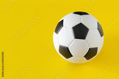 Classic soccer ball on yellow background. Minimal creative concept  copy space 