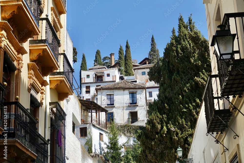View of the Granada neighborhood of Realejo (Spain) with its typical white houses with cypress trees