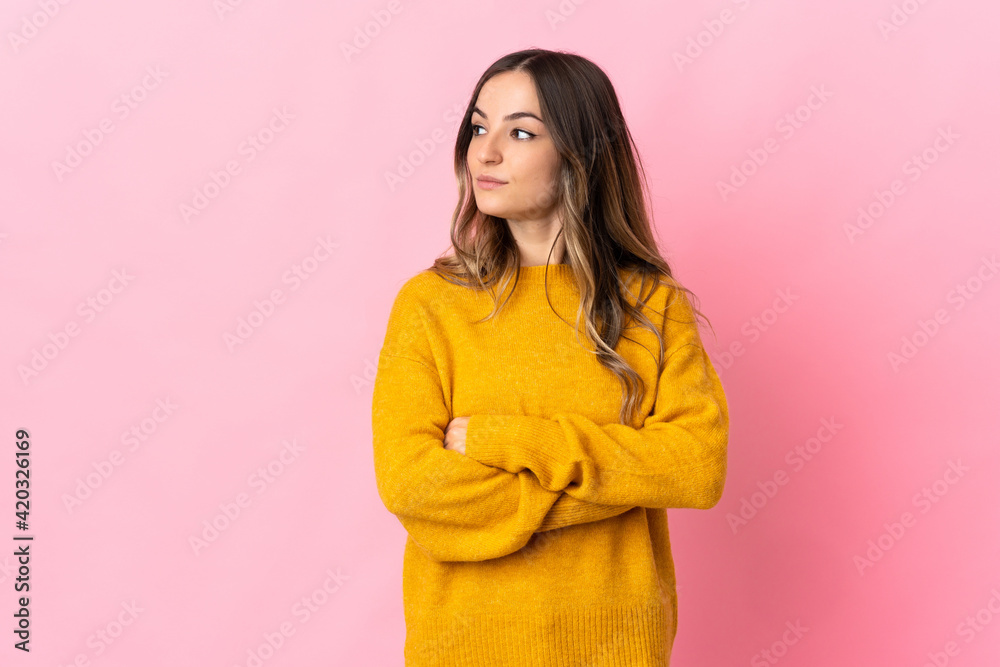 Young Romanian woman isolated on pink background keeping the arms crossed Young Romanian woman isolated on pink background keeping the arms crossed