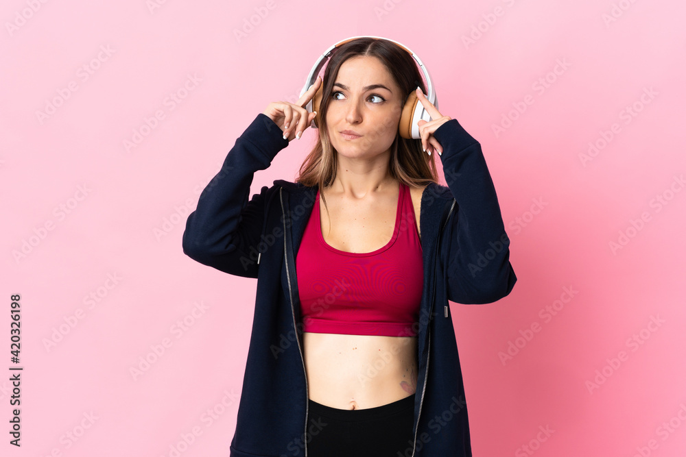 Young Romanian sport woman isolated on pink background having doubts and thinking Young Romanian sport woman isolated on pink background having doubts and thinking