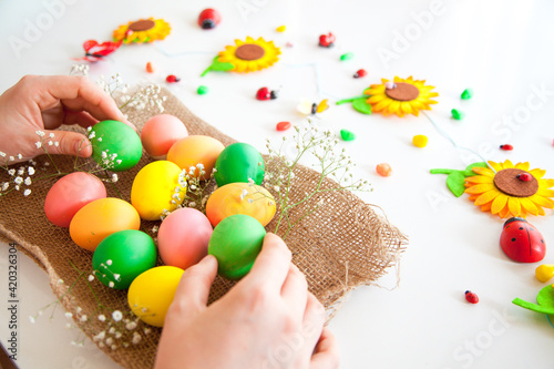 Easter pattern of Eggs with flowers and candies on the white background. Easter concept. Healthy feeding concept.